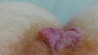 Close up video of a horny redhead fingering her hairy pussy